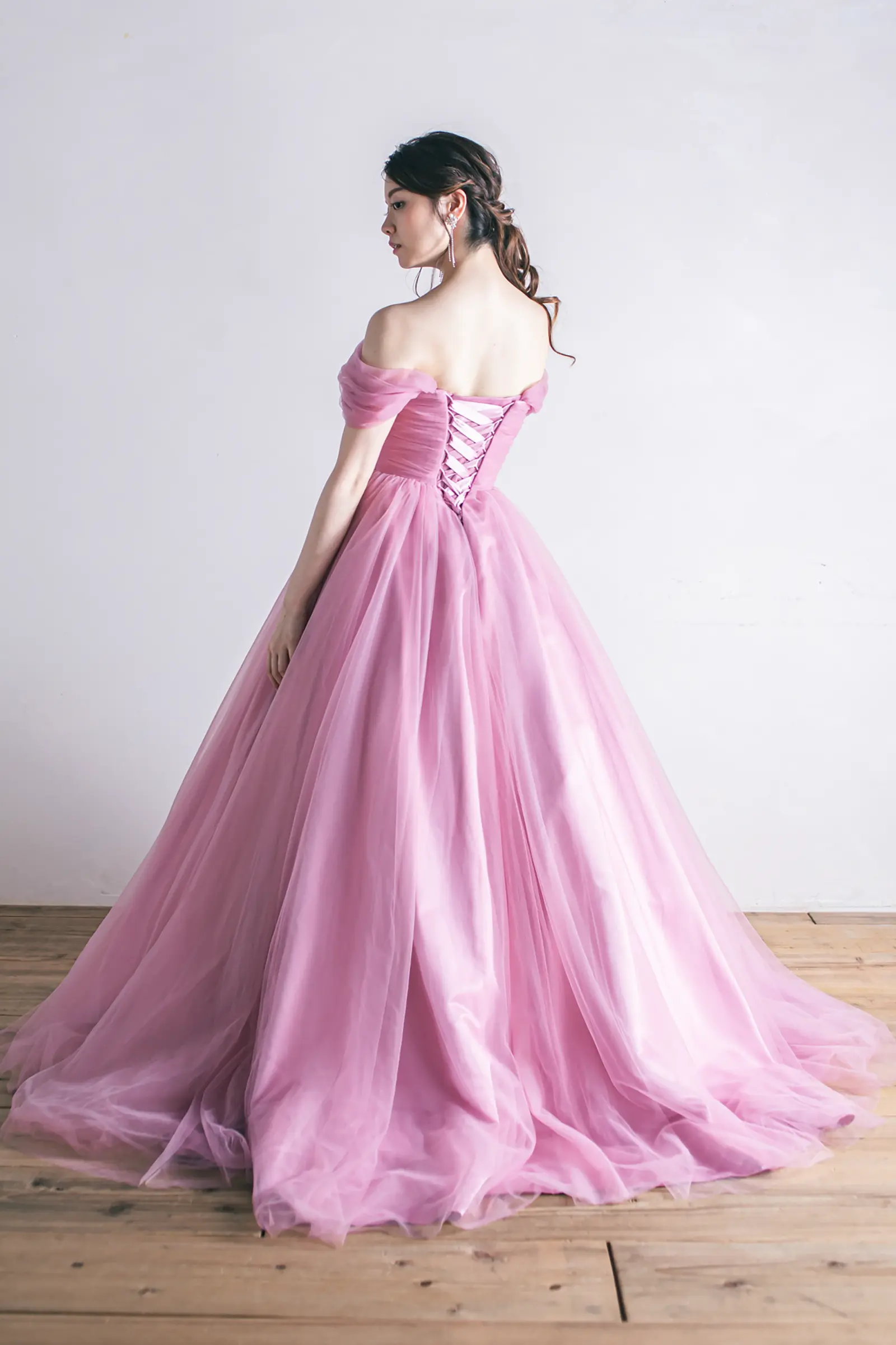 Jellish（ジェリッシュ）の編み上げアッシュピンクドレス。柔らかなチュールが広がるバックスタイル。