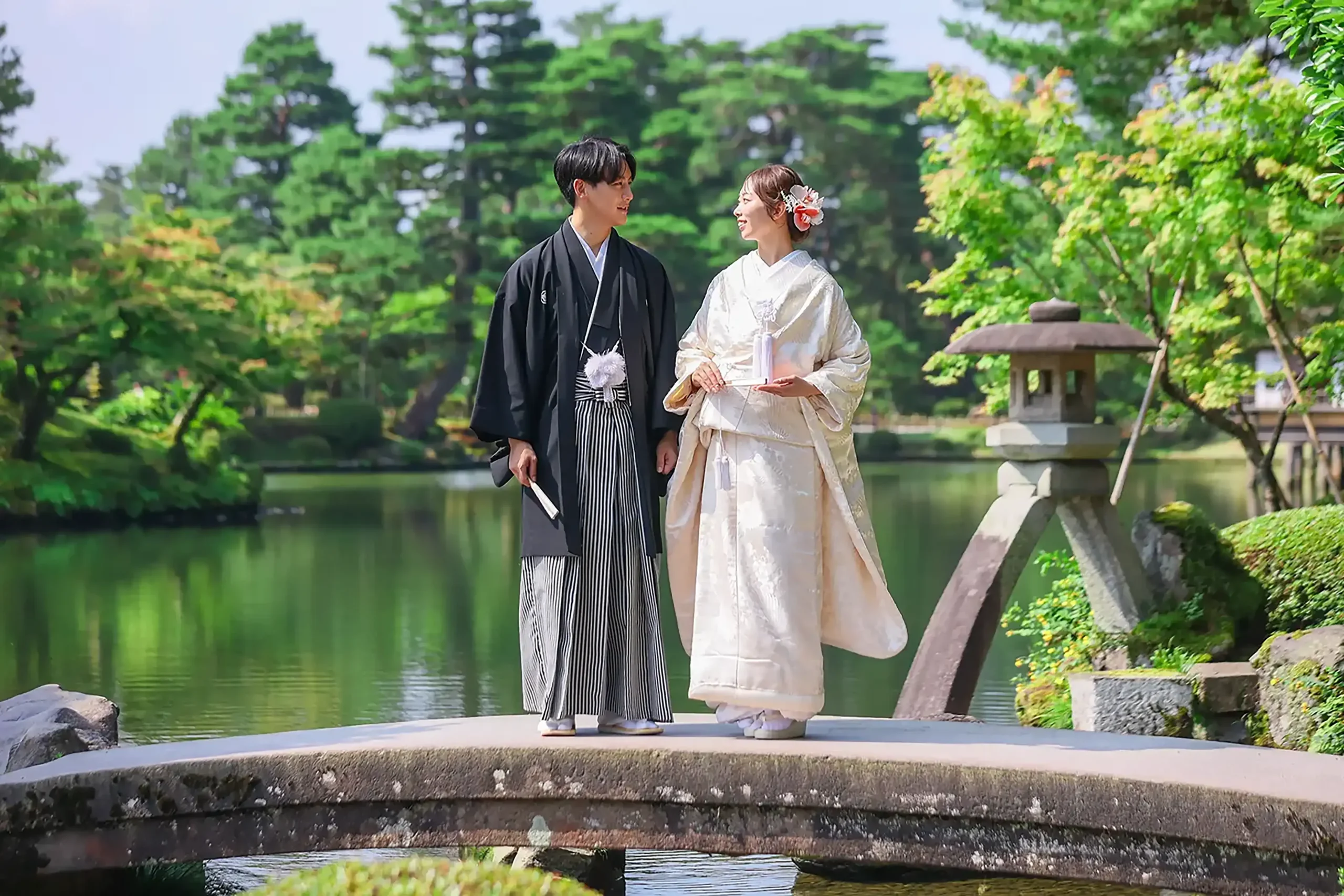 兼六園の橋の上で白無垢と紋付袴を着て撮影する新郎新婦